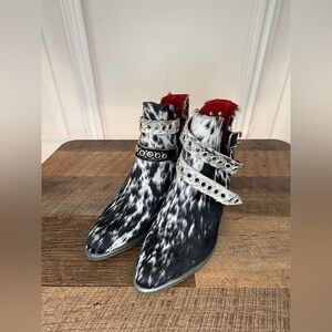 Alcala’s Spotted Black & White Cowhide Ankle Boots with Studded Straps
